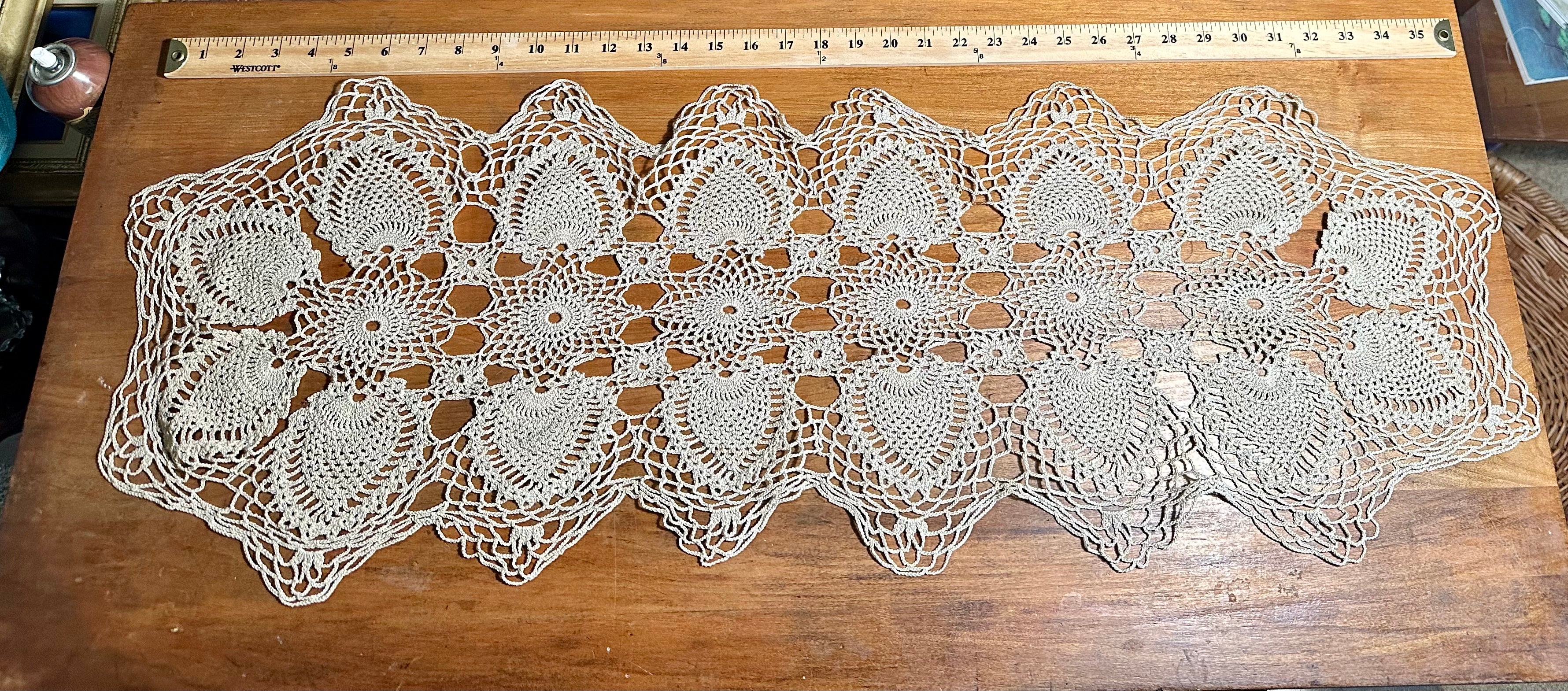 Vintage handmade crocheted ecru lace table runner with a pineapple pattern.